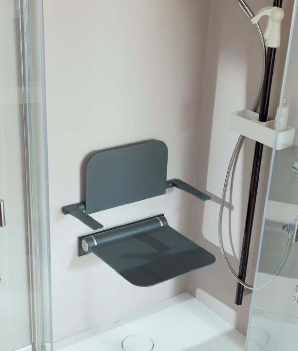 A fold-down shower seat with a backrest and armrests, mounted beside a handheld shower
